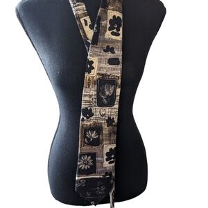 Guy LaRoche silk tie . Black and grey with a floral print.